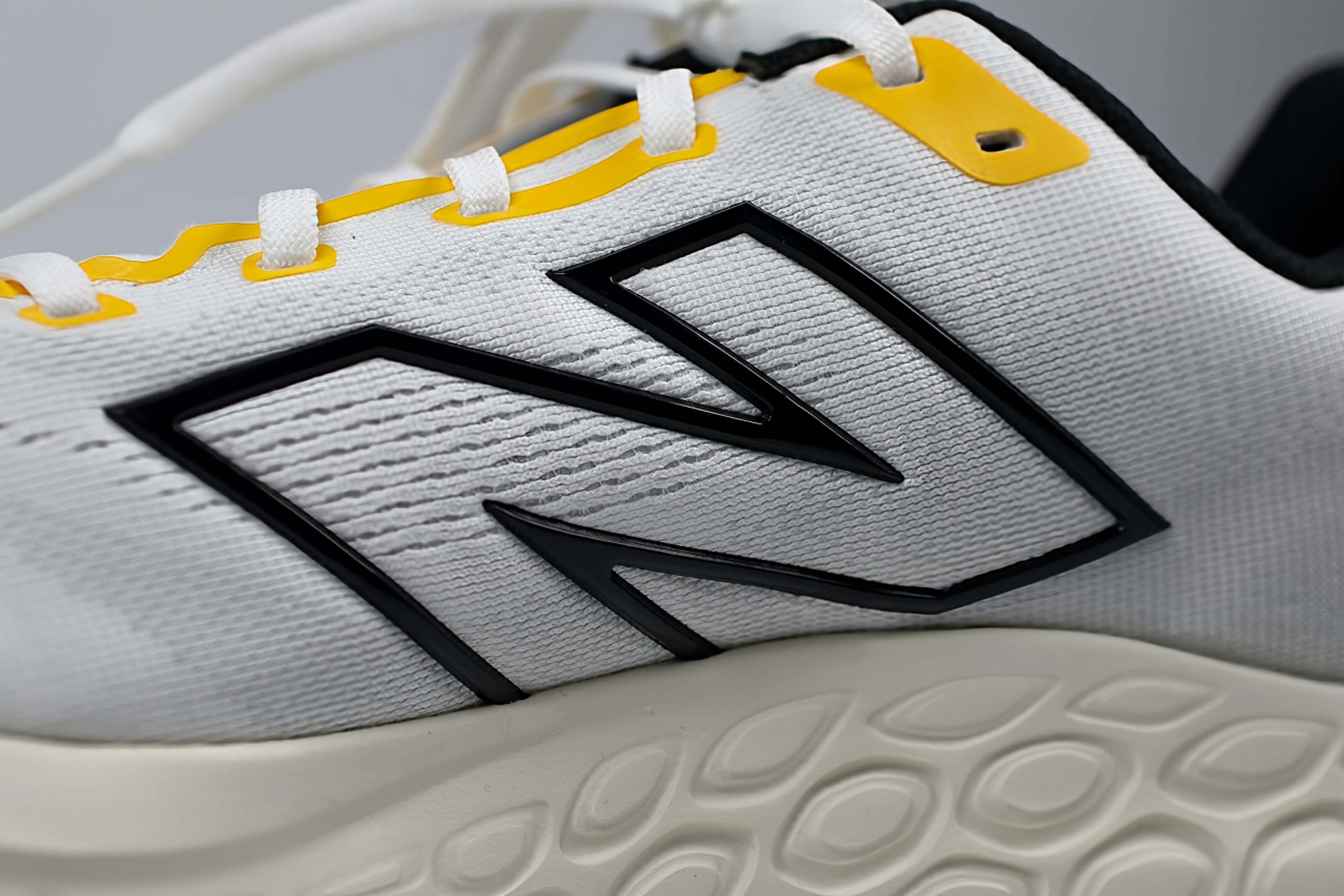 a close up of a white and yellow shoe