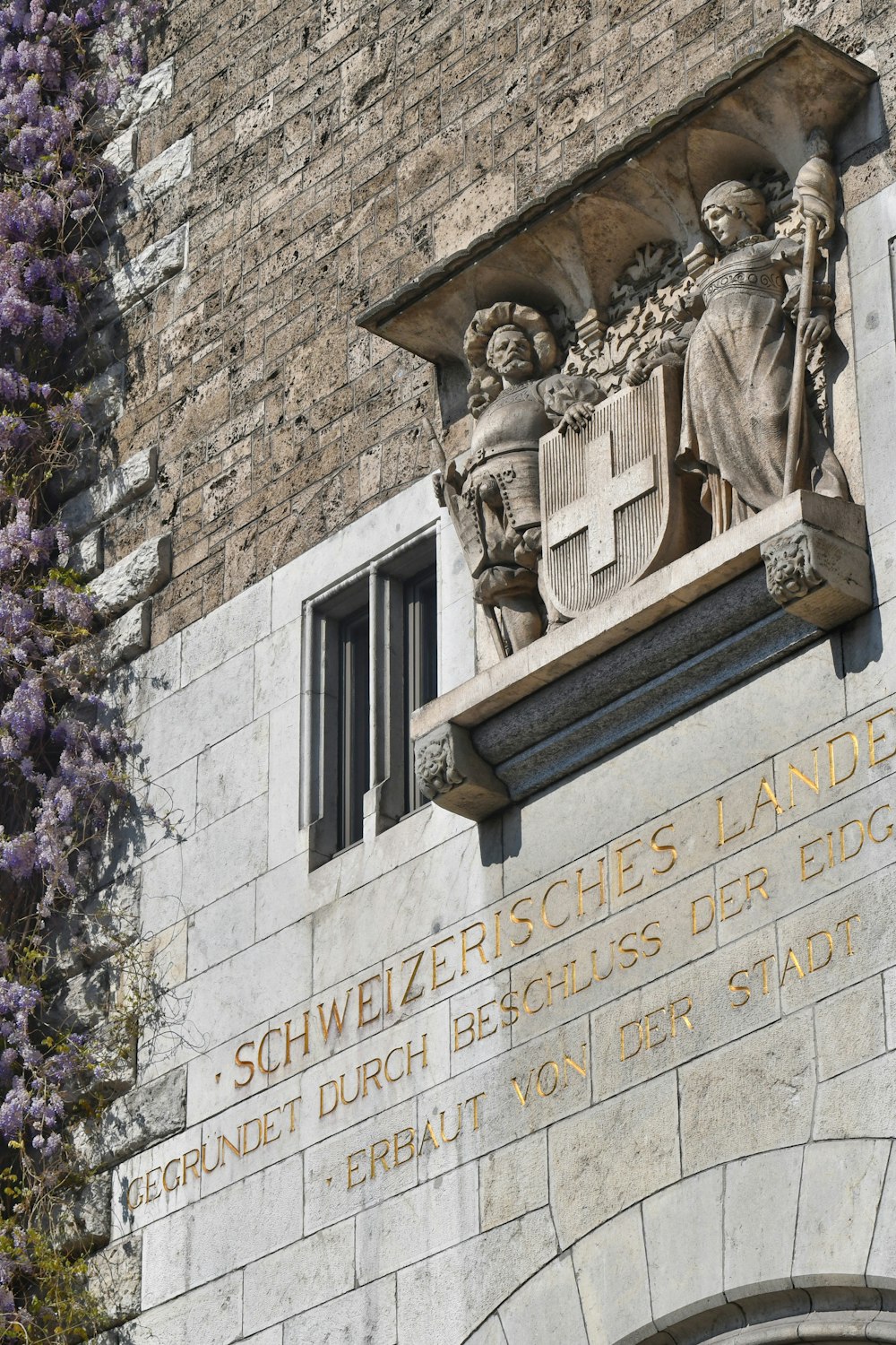 a building with a statue of a man holding a shield