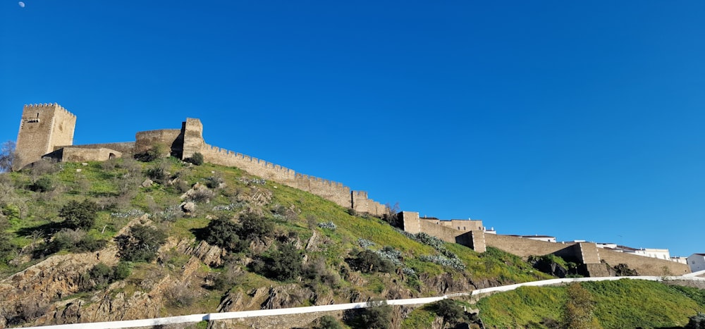 a castle on top of a hill with a sky background