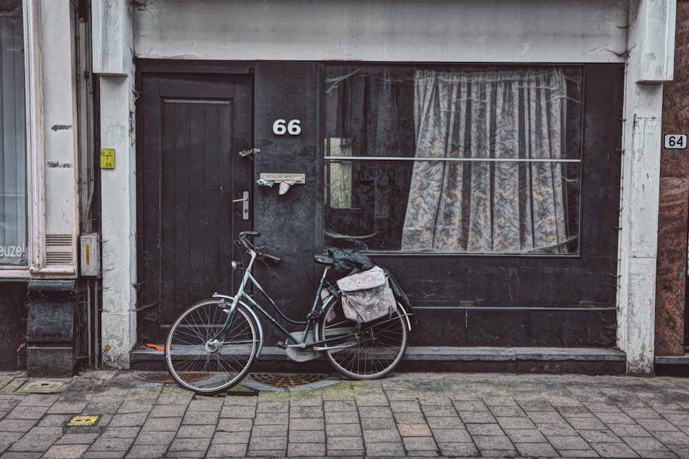 a bicycle parked in front of a black door