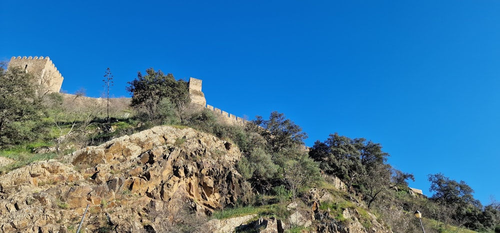 a castle sitting on top of a rocky hill