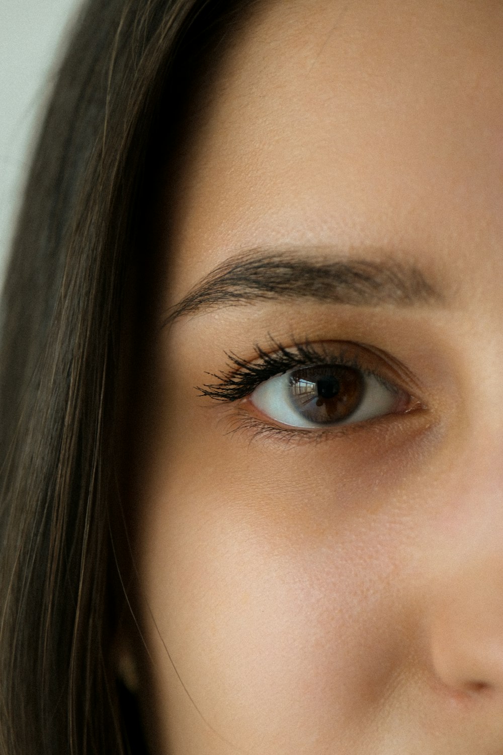 a close up of a woman's eye with long lashes