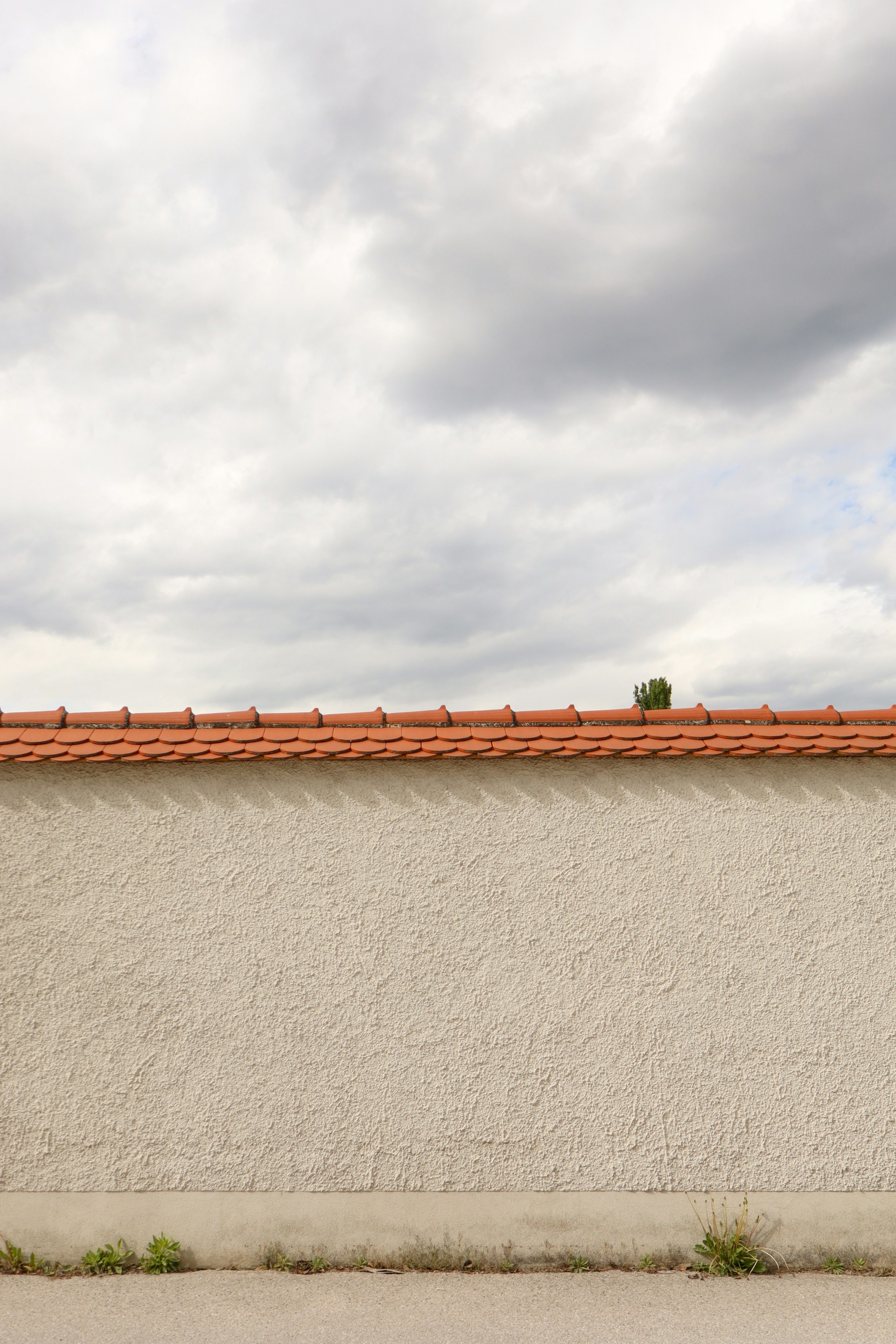 a red fire hydrant sitting on the side of a building