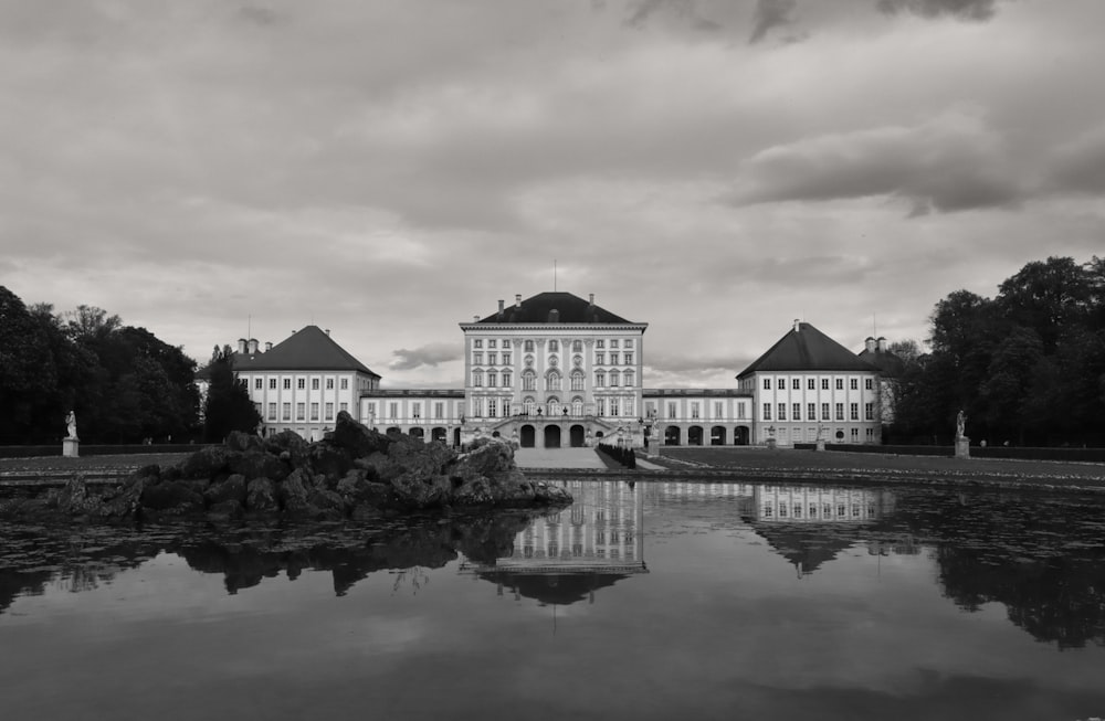 a large building with a pond in front of it