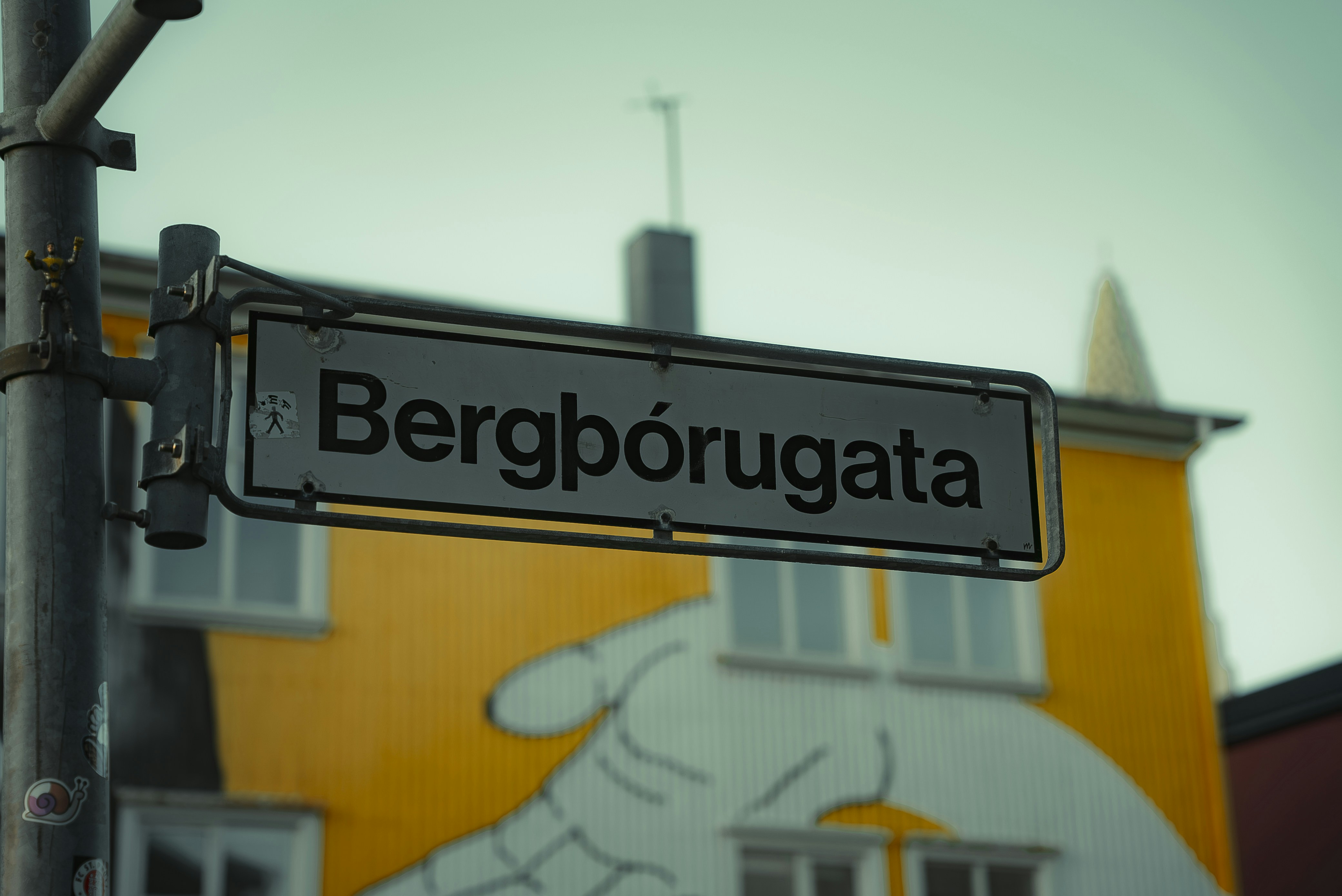 a close up of a street sign with a building in the background