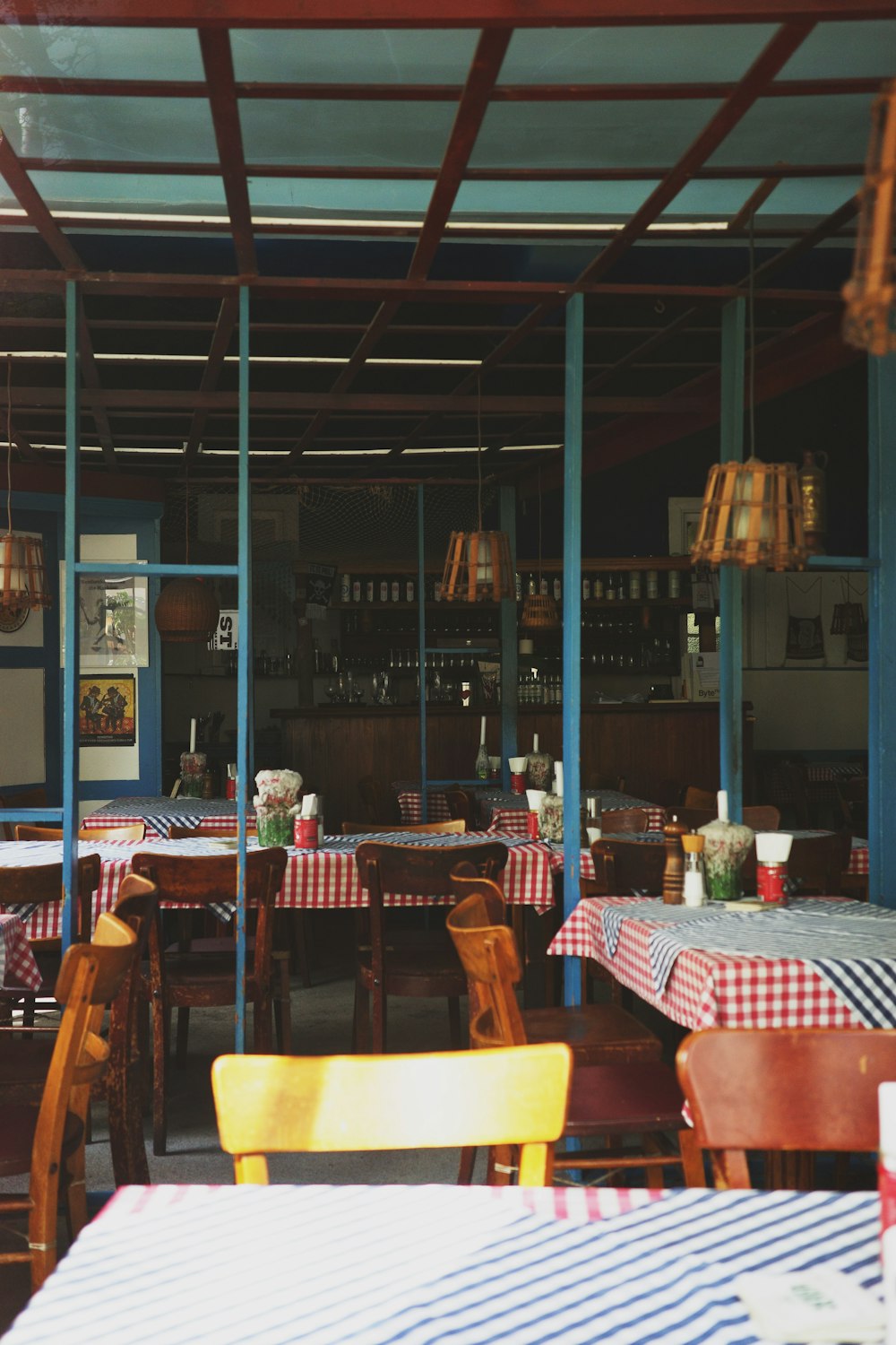 a restaurant with tables and chairs and a blue and white checkered tablecloth