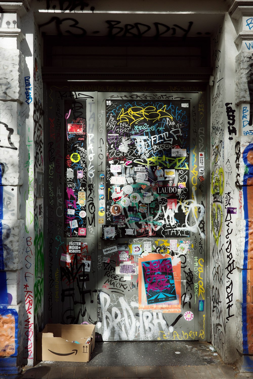 a door covered in lots of graffiti and stickers