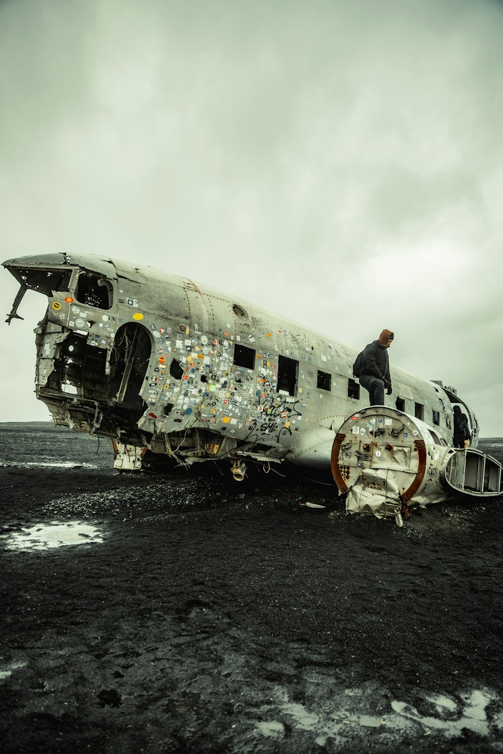 a man standing on top of an old airplane