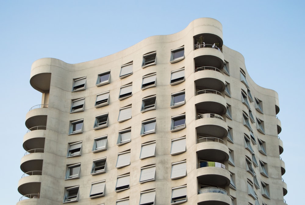 a tall building with balconies and balconies on the windows