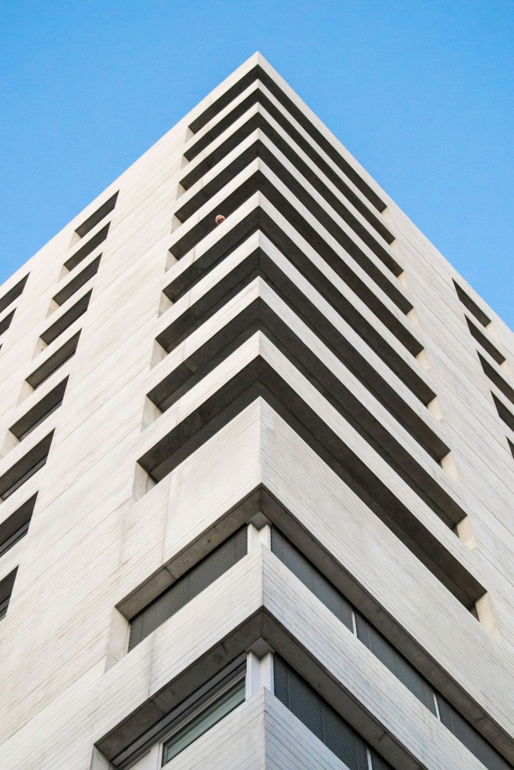 a very tall building with a sky background