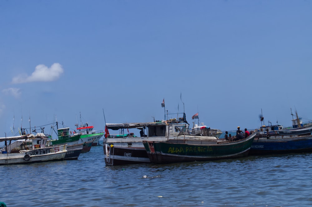 a group of boats floating on top of a body of water