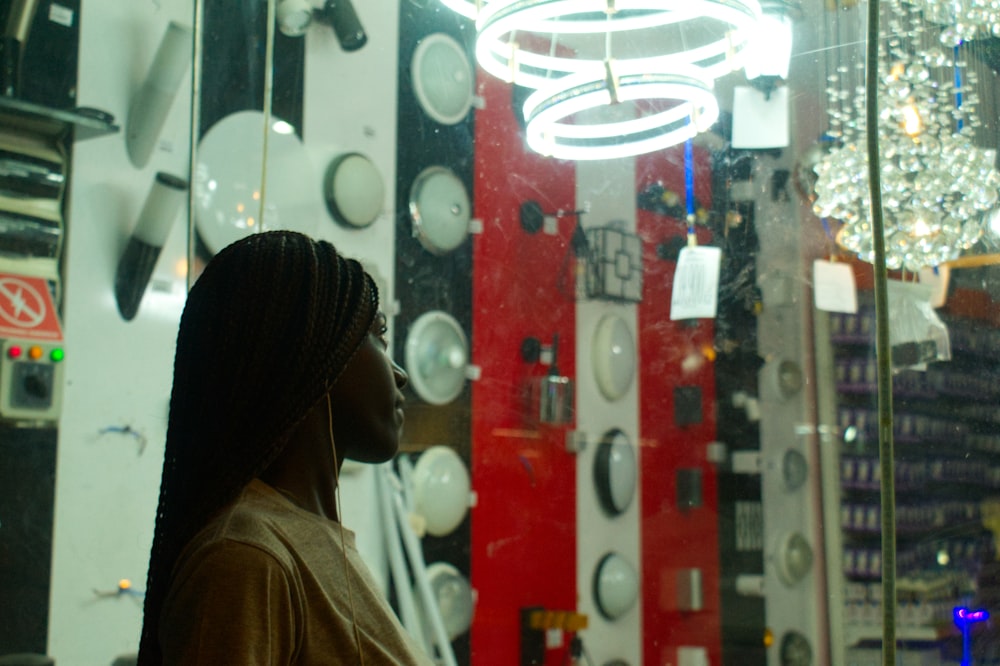 a woman standing in front of a mirror in a store