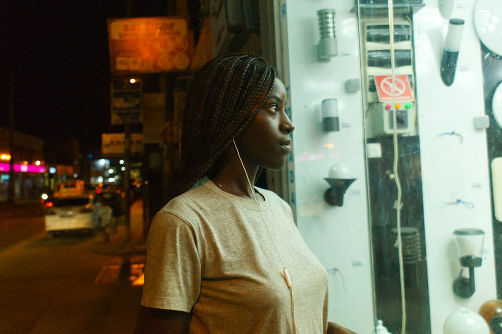 a woman standing in front of a store window