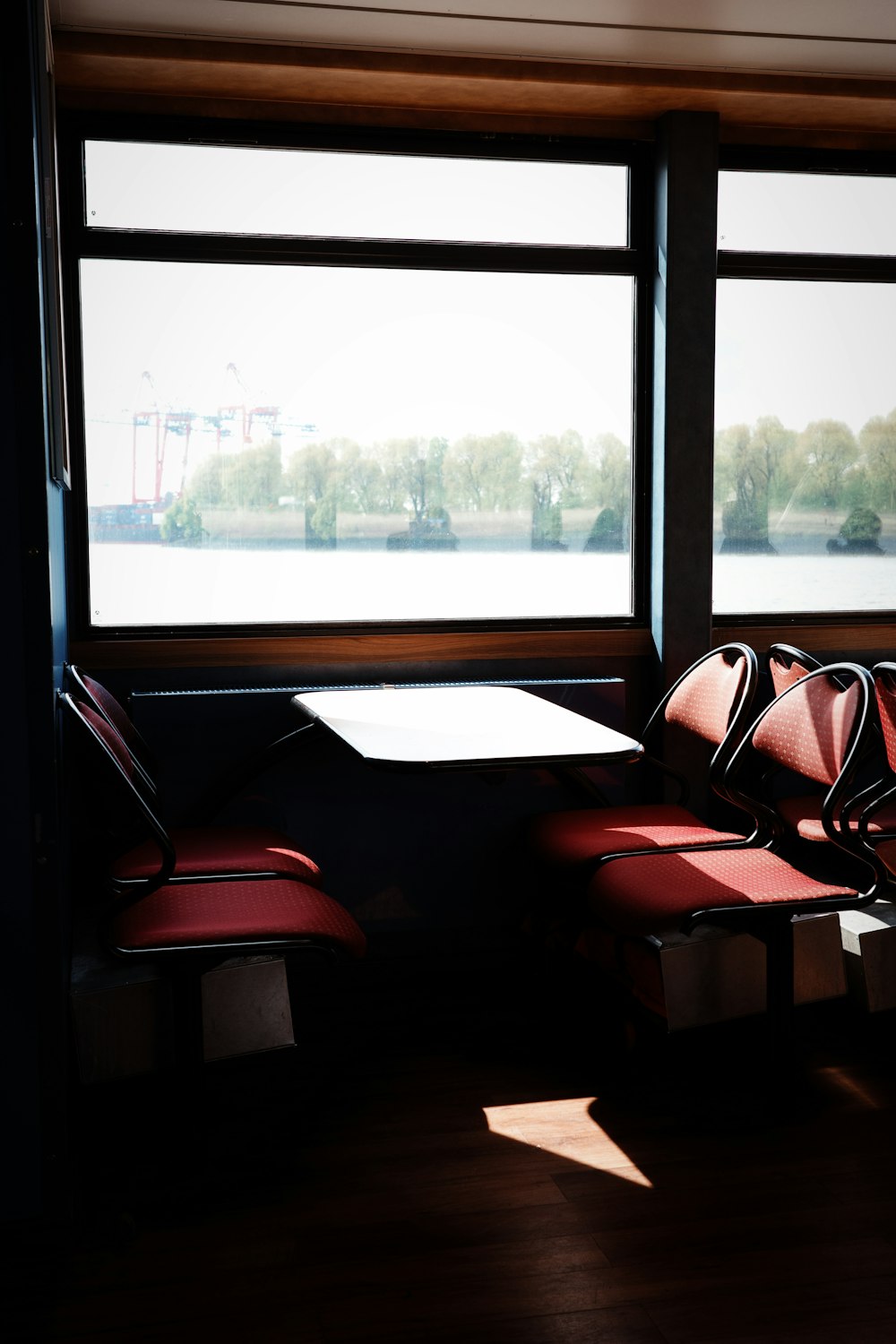 a couple of red chairs sitting next to a window