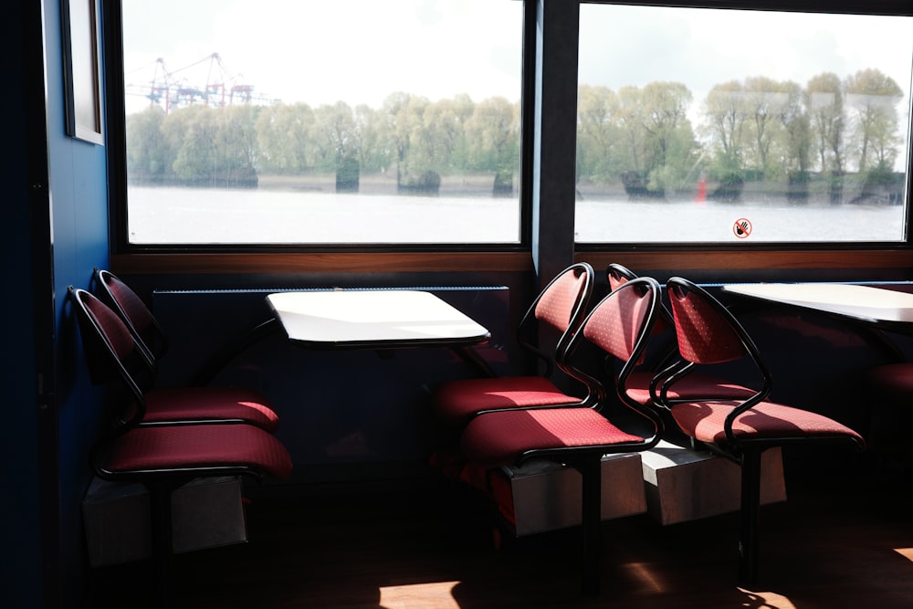 a couple of red chairs sitting next to a window