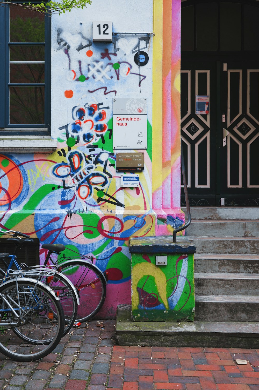 two bikes parked in front of a colorful building
