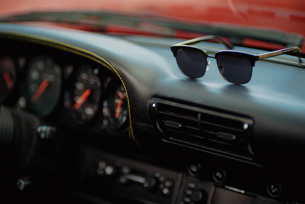 a pair of sunglasses sitting on the dashboard of a car