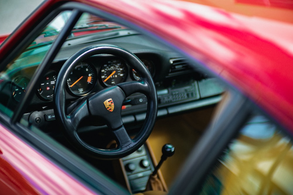 the interior of a car with a steering wheel and dashboard