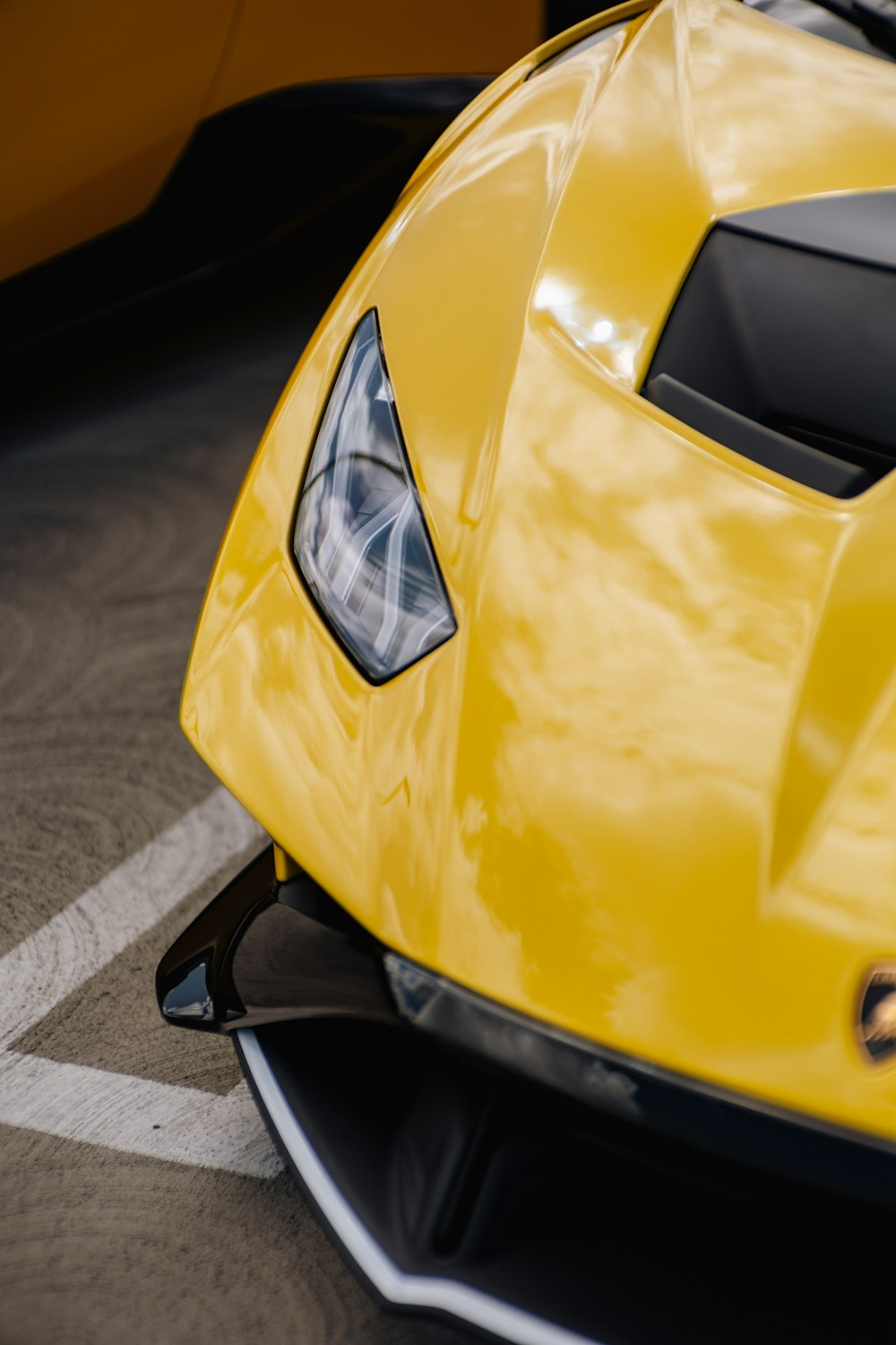 a close up of a yellow sports car