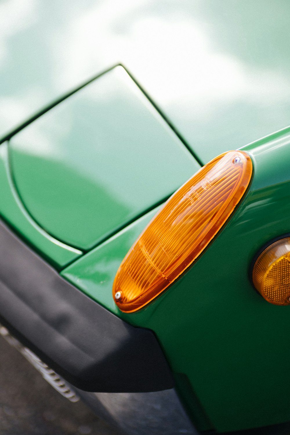 a close up of the tail light of a green sports car