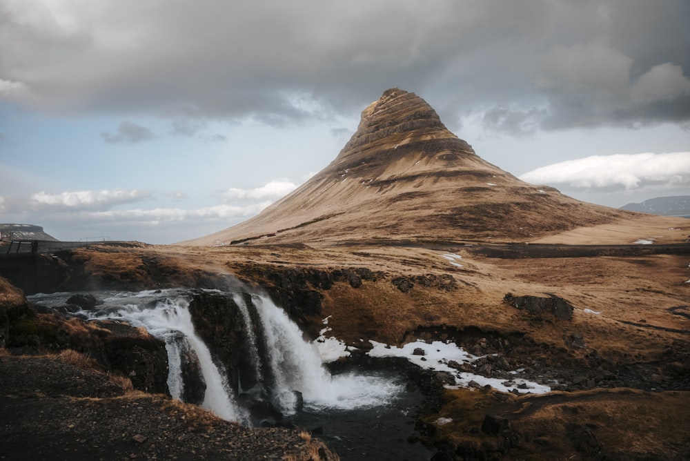 a mountain with a waterfall in front of it