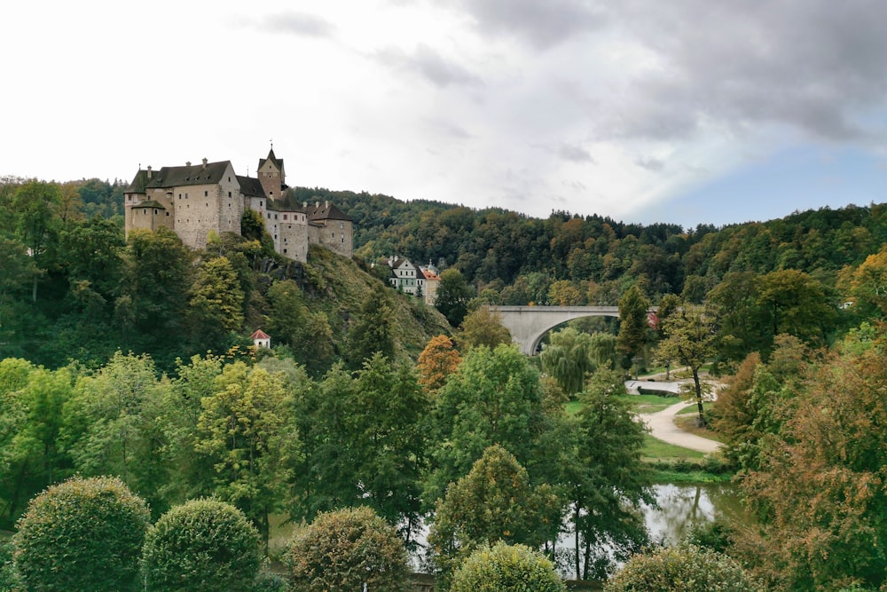 a castle on top of a hill surrounded by trees