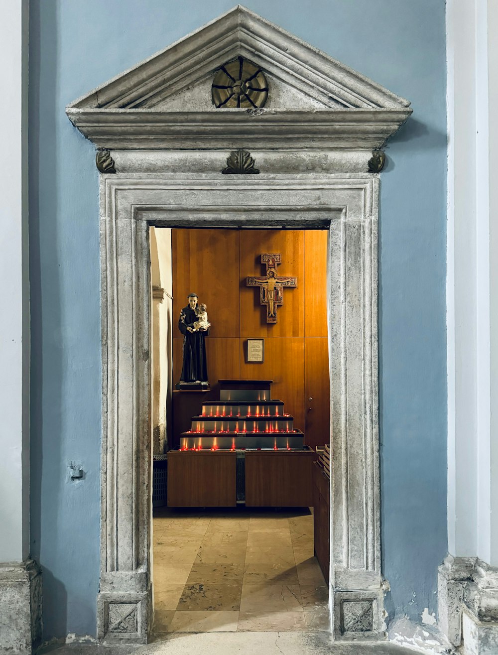 a church with a wooden alter and blue walls