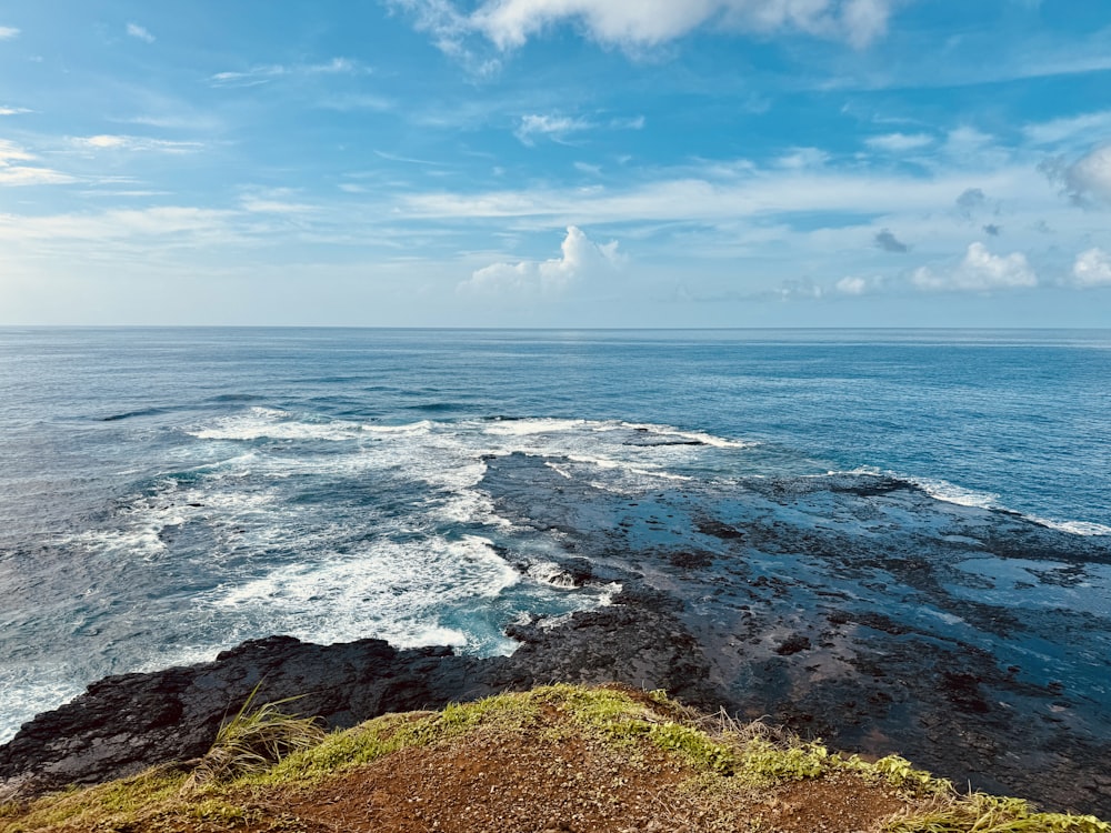 a view of the ocean from the top of a hill