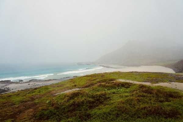 A green hillside above a beach under cloud — Fernando de Noronha, Brazil