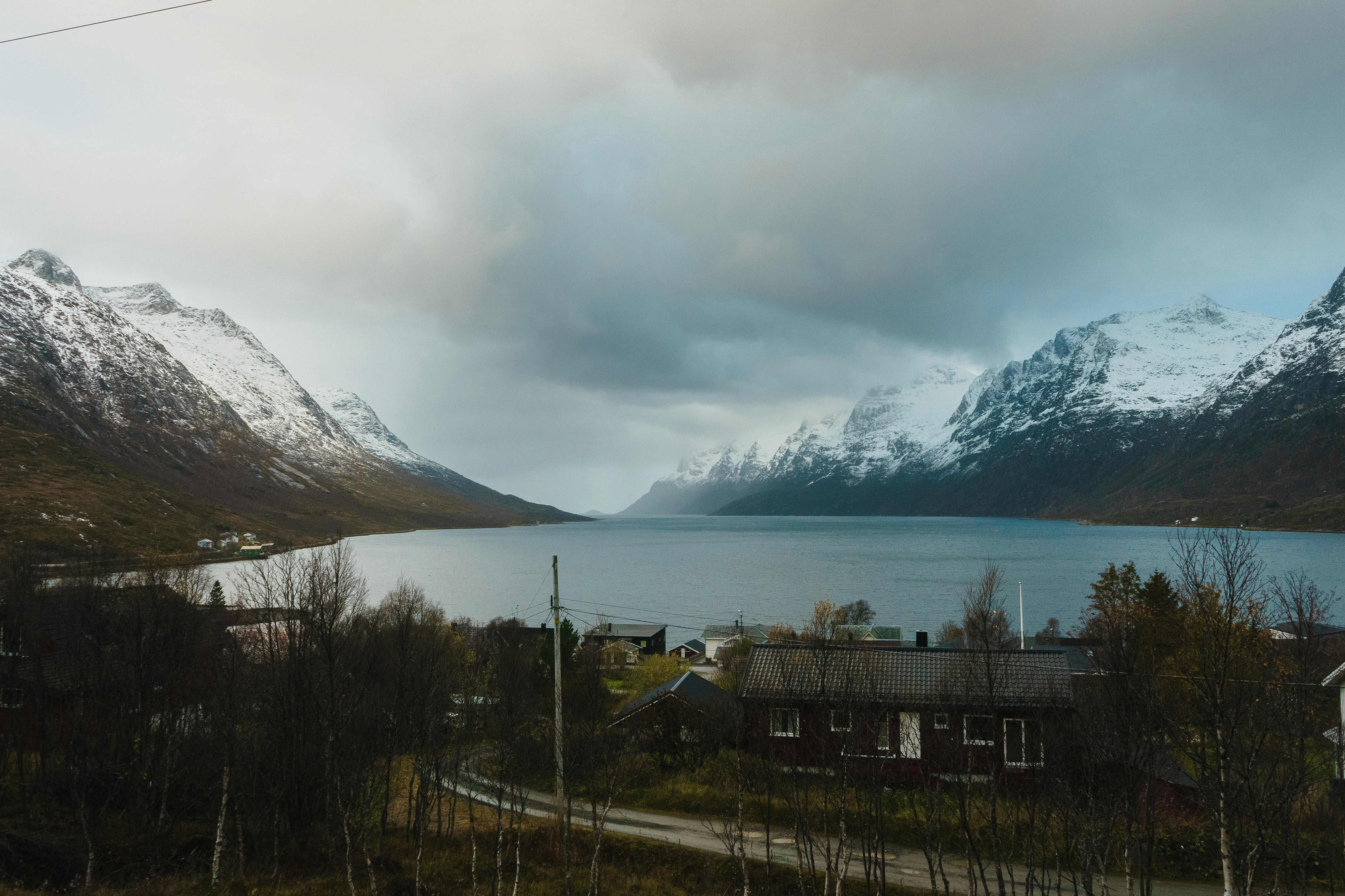 a view of a mountain range with a lake in the foreground