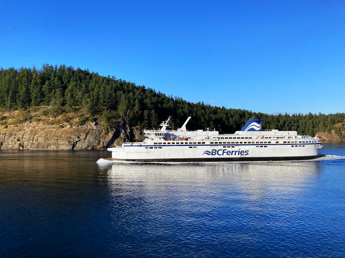 BC Ferries vessel arriving through forested waters