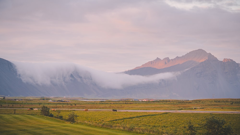 a mountain range with clouds rolling over it