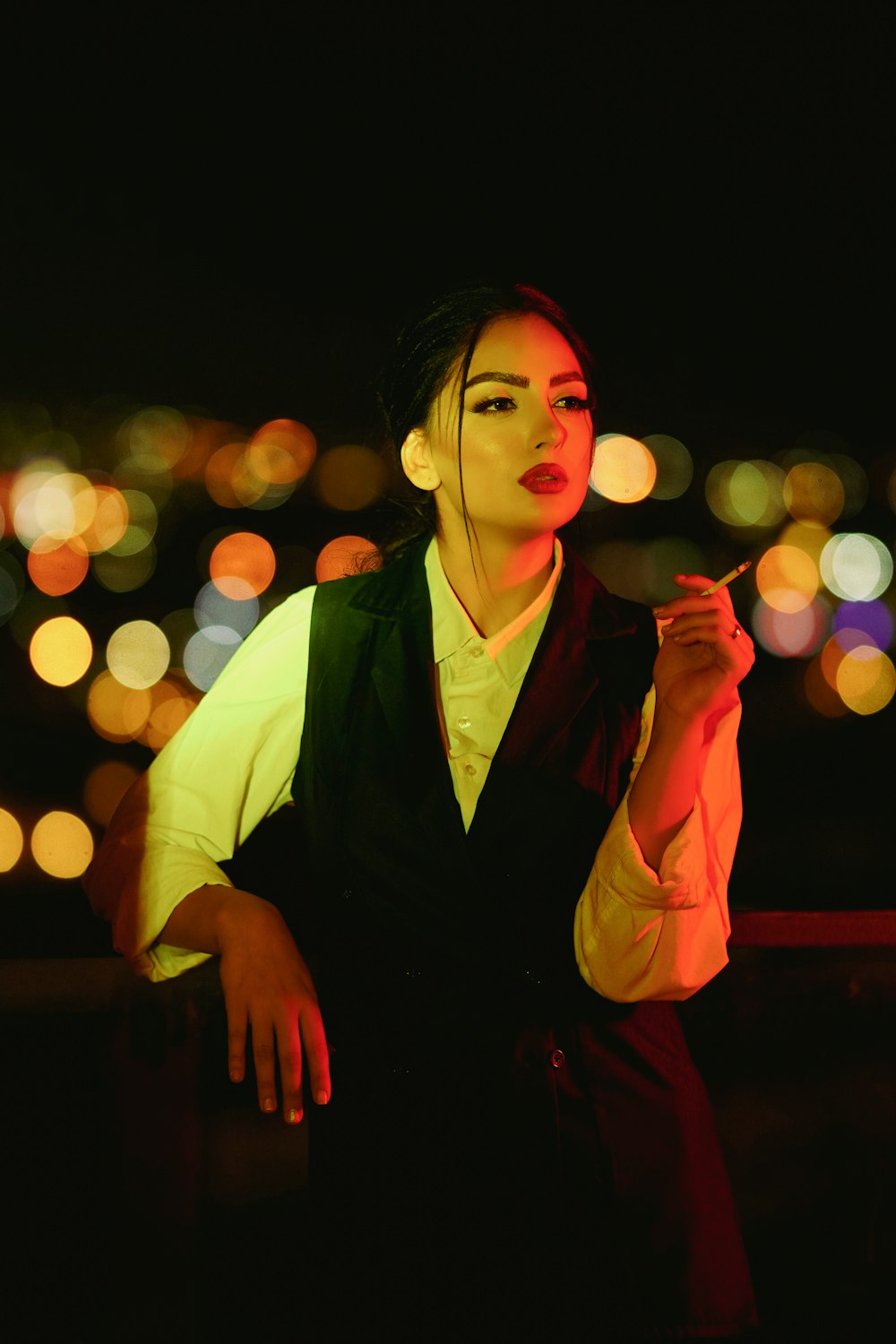 a woman standing in the dark with headphones on