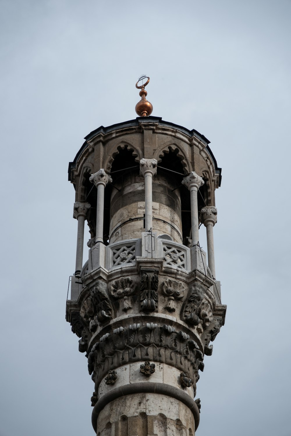 a tall tower with a statue on top of it