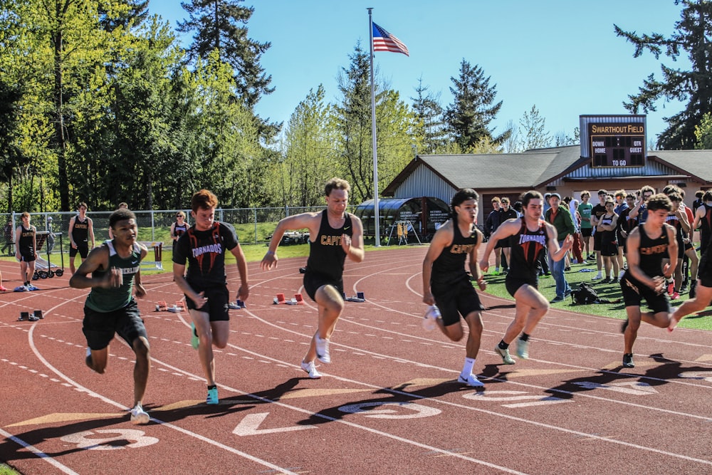 a group of people running on a track