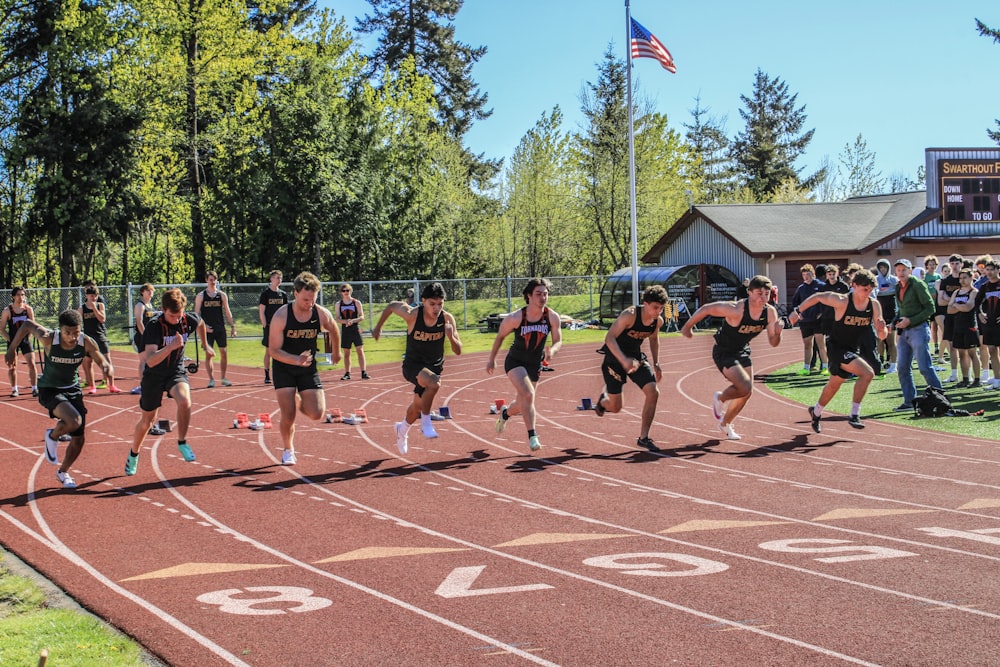 a group of people running on a track