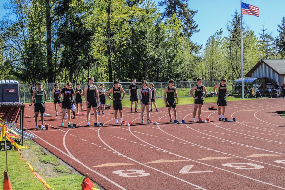 a group of people standing on top of a track