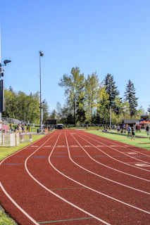 a red track running through a lush green field