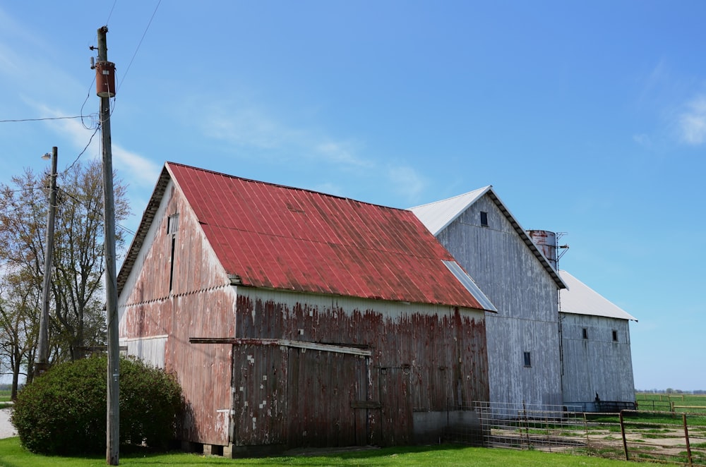 a barn with a red roof and a red tin roof