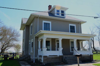 a gray house with a large front porch