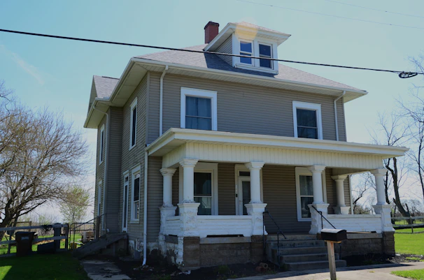 a gray house with a large front porch