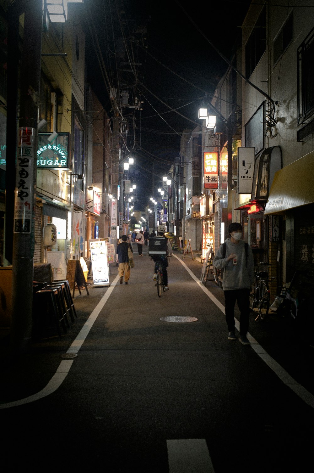 a couple of people riding bikes down a street