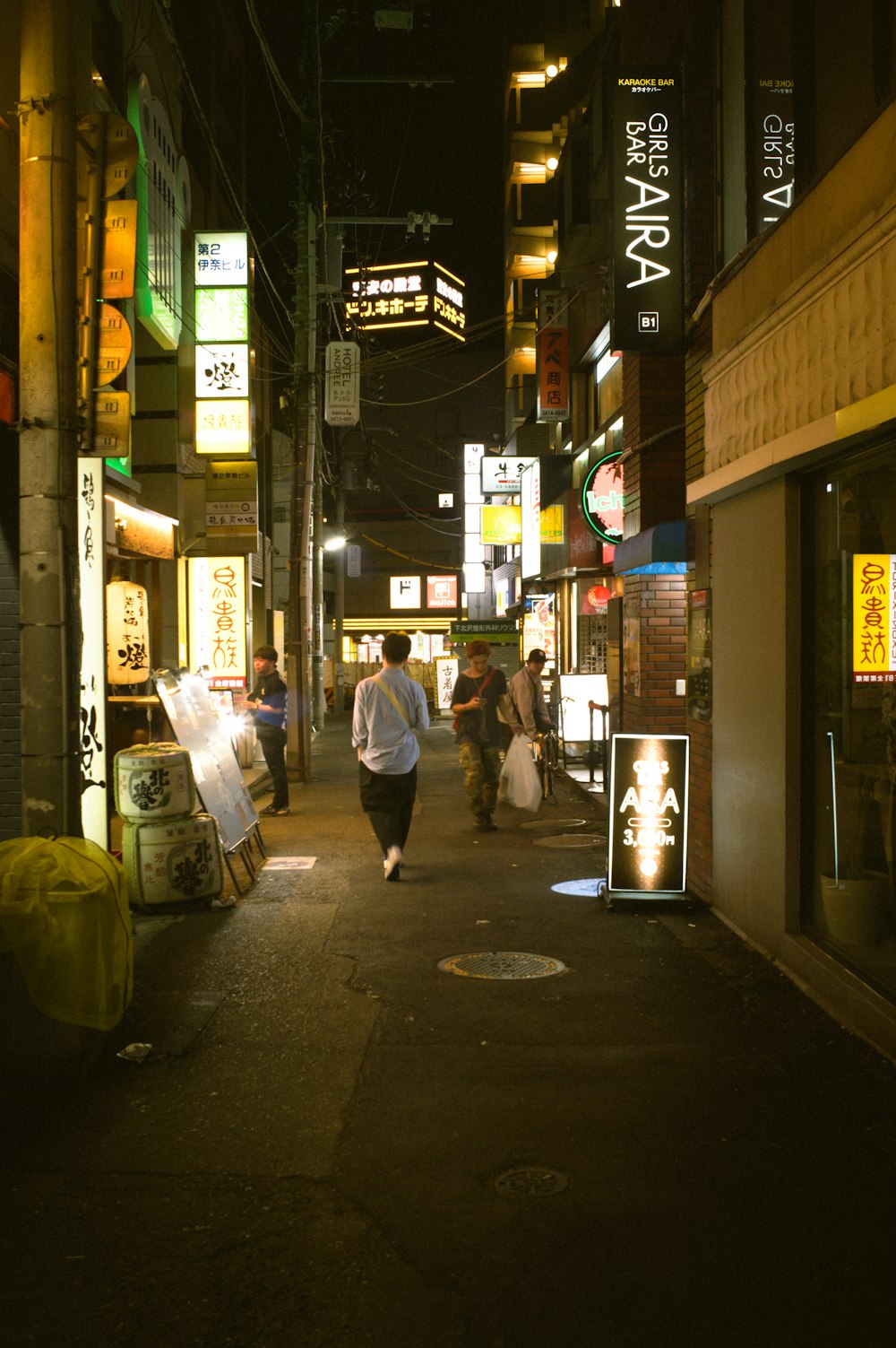 a person walking down a street at night