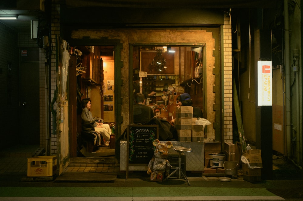 a couple of people sitting outside of a building