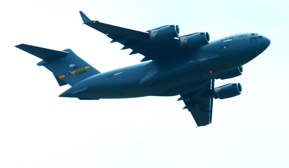 a large jetliner flying through a blue sky