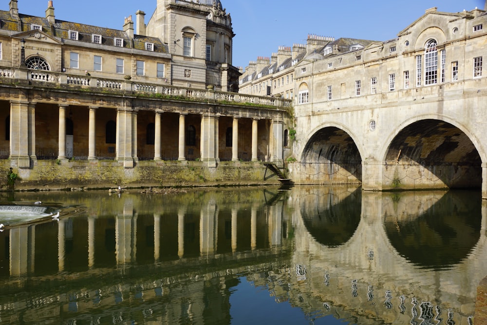 a bridge over a body of water next to a building