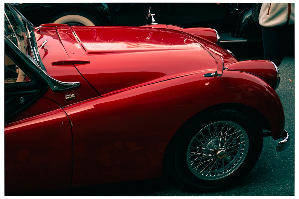 a red sports car parked on the side of the road