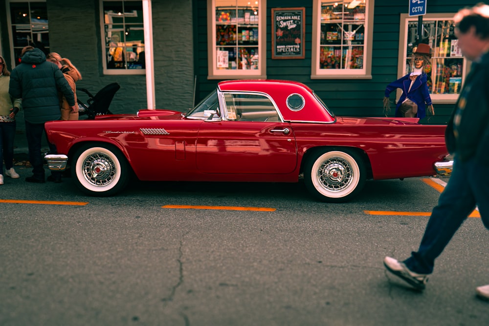 a red car parked in front of a store