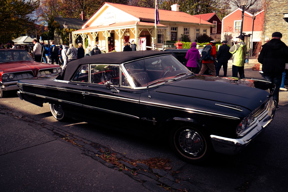 a black car parked on the side of the road