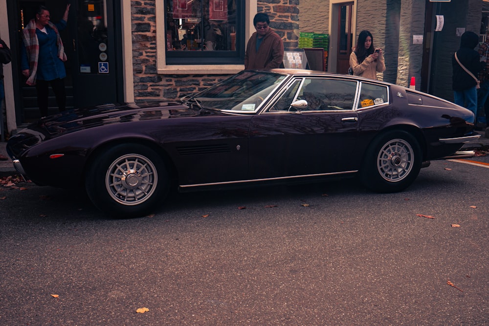 a black sports car parked in front of a building